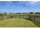 Scenic backyard view with a black fence, showcasing a pond, playground, and green space in a Gathering-friendly community at 2232 Warbler St, Danville, IN 46122