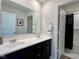 Bathroom with double vanity, framed mirror, and shower/tub with modern tile at 2232 Warbler St, Danville, IN 46122