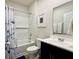 Bathroom featuring a shower tub combination with a decorative curtain, a toilet, and dark vanity at 2232 Warbler St, Danville, IN 46122