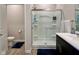 Bathroom featuring a glass enclosed shower with shelves, a toilet, and dark colored vanity at 2232 Warbler St, Danville, IN 46122