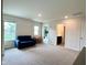 Spacious bonus room featuring a cozy couch, table, chairs and open entry to other rooms at 2232 Warbler St, Danville, IN 46122
