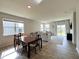 Dining room with a table, chairs, large windows, and open access to the living room at 2232 Warbler St, Danville, IN 46122