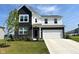 Two-story home featuring a brick and siding exterior, well-manicured lawn, and a two-car garage at 2232 Warbler St, Danville, IN 46122