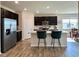 Modern kitchen with stainless steel appliances, island with seating, and open access to the dining area at 2232 Warbler St, Danville, IN 46122