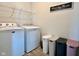 Well equipped laundry room, including washer, dryer, overhead storage, and stylish storage bins at 2232 Warbler St, Danville, IN 46122