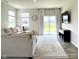 Living room with natural light, comfortable seating, and a sliding glass door to the backyard at 2232 Warbler St, Danville, IN 46122