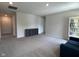 Neutral living room featuring cozy carpet, built in bookcase and storage unit, plus a comfortable blue sofa at 2232 Warbler St, Danville, IN 46122
