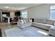 Open-concept living space with a kitchen island, dining area, and comfortable living room seating at 2232 Warbler St, Danville, IN 46122