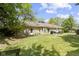 Expansive backyard with a stone exterior, manicured lawn, and mature trees at 2315 Elm Swamp Rd, Lebanon, IN 46052