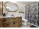 Updated bathroom featuring a wood vanity with marble countertop and a floral shower curtain at 2315 Elm Swamp Rd, Lebanon, IN 46052
