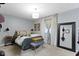 Bright bedroom featuring a comfortable queen-sized bed, carpet floors, and a modern ceiling light at 2315 Elm Swamp Rd, Lebanon, IN 46052