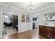 Cozy dining room featuring elegant chandelier, hardwood floors, and stylish decor creating a welcoming atmosphere at 2315 Elm Swamp Rd, Lebanon, IN 46052