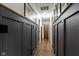 Long hallway featuring unique black panelling and wood-look flooring, leading to various rooms at 2315 Elm Swamp Rd, Lebanon, IN 46052