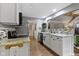 Modern kitchen featuring white cabinets, granite countertops, and stainless steel appliances with dining area views at 2315 Elm Swamp Rd, Lebanon, IN 46052