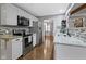 Contemporary kitchen with stainless steel appliances, white cabinets, and a view into an adjacent dining area at 2315 Elm Swamp Rd, Lebanon, IN 46052