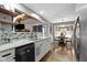 Well-lit kitchen showcasing granite countertops, modern backsplash, and open layout leading to the dining area at 2315 Elm Swamp Rd, Lebanon, IN 46052