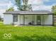 Backyard featuring a small house with a covered patio and green grass at 3101 Gerrard Ave, Indianapolis, IN 46224