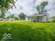Large green lawn in the backyard, with a small house and covered patio at 3101 Gerrard Ave, Indianapolis, IN 46224