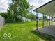 Large backyard covered in green grass with a covered patio at the back of the house at 3101 Gerrard Ave, Indianapolis, IN 46224