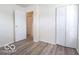 A bright bedroom features light gray wood floors and a closet with white doors at 3101 Gerrard Ave, Indianapolis, IN 46224