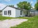 Exterior view of a white house with a gravel driveway and a covered back porch at 3101 Gerrard Ave, Indianapolis, IN 46224