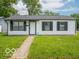 Inviting home featuring a classic design, a manicured lawn and a welcoming entrance at 3101 Gerrard Ave, Indianapolis, IN 46224