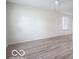 Bright, spacious living room with new flooring and fresh paint offers a blank canvas at 3101 Gerrard Ave, Indianapolis, IN 46224