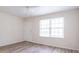 Bright living room with light-colored walls, new flooring, and a ceiling fan at 3101 Gerrard Ave, Indianapolis, IN 46224