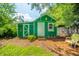 The backyard shed features new paint, landscaping, and offers a delightful, calming backyard view at 317 Stoner Dr, Anderson, IN 46013
