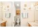 Bathroom with hardwood cabinets, a toilet, a sink, framed art, a mirror and a towel rack at 317 Stoner Dr, Anderson, IN 46013