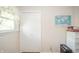 Bright bedroom with a window, a world map, a closet, an outlet, and a cabinet against a tan wall at 317 Stoner Dr, Anderson, IN 46013