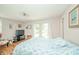 Bedroom with hardwood floors, a floral patterned bed, a TV on a stand, curtains, and a ceiling fan at 317 Stoner Dr, Anderson, IN 46013