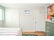 Bedroom with wooden floors, a floral patterned bed, two closets, a dresser, and a painting at 317 Stoner Dr, Anderson, IN 46013