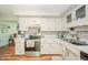 Bright kitchen featuring white cabinets, stainless steel appliances, and a modern subway tile backsplash at 317 Stoner Dr, Anderson, IN 46013