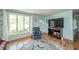 Cozy living room with plush armchair, large window and modern media console at 317 Stoner Dr, Anderson, IN 46013