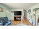 Bright living room with hardwood floors and updated furniture at 317 Stoner Dr, Anderson, IN 46013