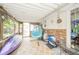 Enclosed sunroom features cozy seating, unique decor, and plenty of natural light at 317 Stoner Dr, Anderson, IN 46013