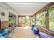 Large sunroom with a tiled floor and a wall of windows offers views of the outdoors at 317 Stoner Dr, Anderson, IN 46013