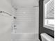 A bright bathroom features white subway tiles, bathtub, and modern chrome fixtures at 329 Parkway Ave, Indianapolis, IN 46225