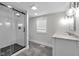 Modern bathroom with walk-in shower, tile floors, and bright vanity lighting at 329 Parkway Ave, Indianapolis, IN 46225
