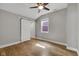 A bright bedroom with hardwood floors, ceiling fan, and sliding barn door at 329 Parkway Ave, Indianapolis, IN 46225