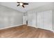 A spacious bedroom with hardwood floors, ceiling fan and double door closet at 329 Parkway Ave, Indianapolis, IN 46225