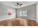 A spacious bedroom with hardwood floors, windows, and ceiling fan at 329 Parkway Ave, Indianapolis, IN 46225
