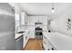 Bright, modern kitchen with stainless steel appliances and white cabinetry at 329 Parkway Ave, Indianapolis, IN 46225