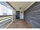 Covered front porch with wood flooring and white railings at 329 Parkway Ave, Indianapolis, IN 46225