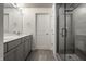 Modern bathroom featuring dual sink vanity and a glass-enclosed shower with gray tiling at 350 N Meridian St # 606/607, Indianapolis, IN 46204