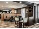 Dining area with modern built-in booth, stylish light fixture, and an adjacent bar area with barstool seating at 350 N Meridian St # 606/607, Indianapolis, IN 46204