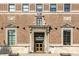 A classic brick building entrance with elegant stone details and an American flag at 350 N Meridian St # 606/607, Indianapolis, IN 46204
