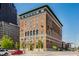 Spacious brick building with green roof trim against a bright blue sky on a sunny day at 350 N Meridian St # 606/607, Indianapolis, IN 46204