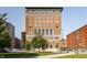Brick building with arched windows surrounded by green trees and a well-manicured lawn at 350 N Meridian St # 606/607, Indianapolis, IN 46204